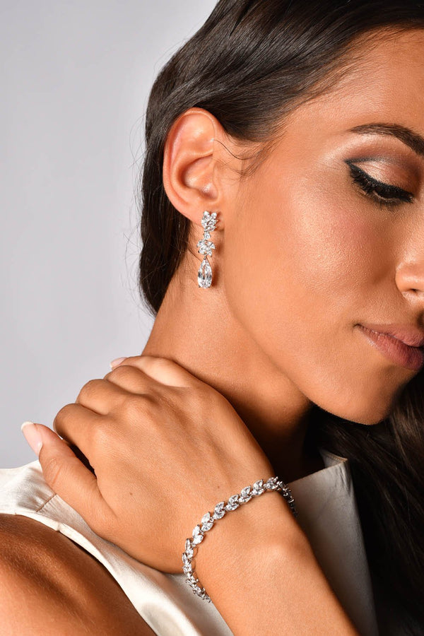 Woman wearing a crystal bracelet and crystal drop earrings