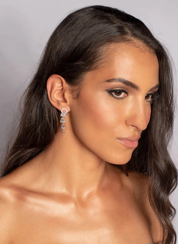 Woman wearing tiered drop silver cluster crystal earrings 