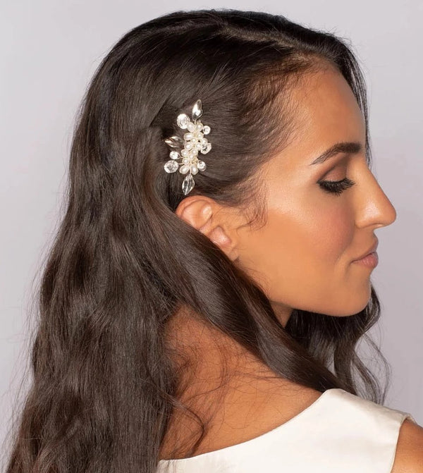 Woman with Crystals and pearls bridal hair comb on white background