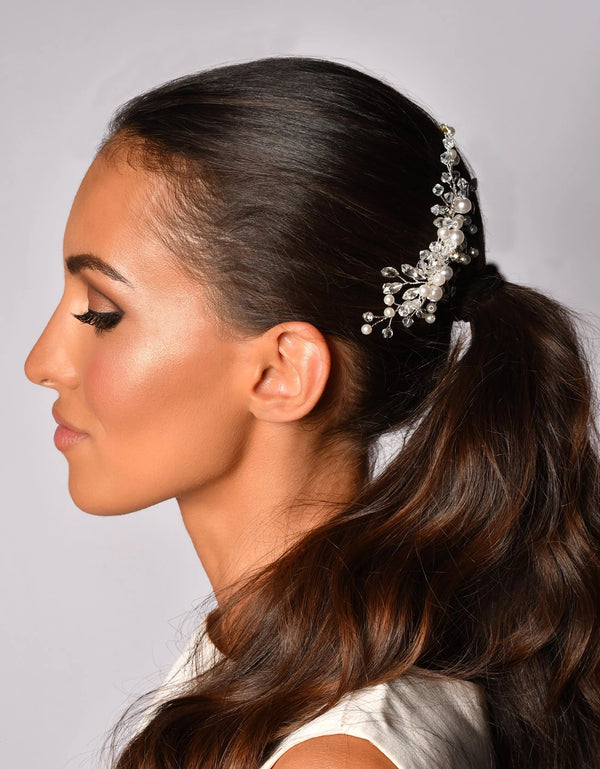 Woman with a Floral bridal hair comb with crystals and pearls on white background 