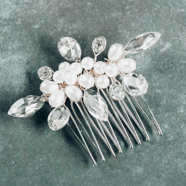 Crystals and pearls bridal hair comb on a gray background