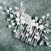 Floral bridal hair comb with crystals and pearls on gray background