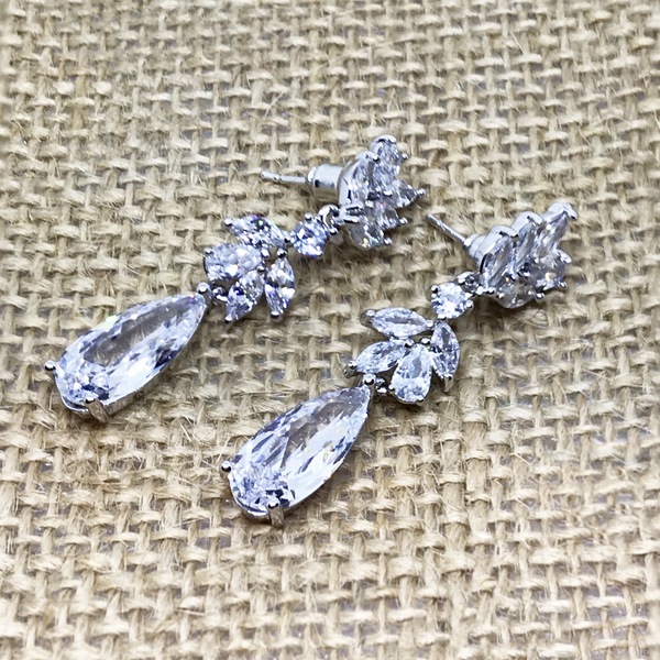 silver swarovski crystal rain drop earrings on a burlap background