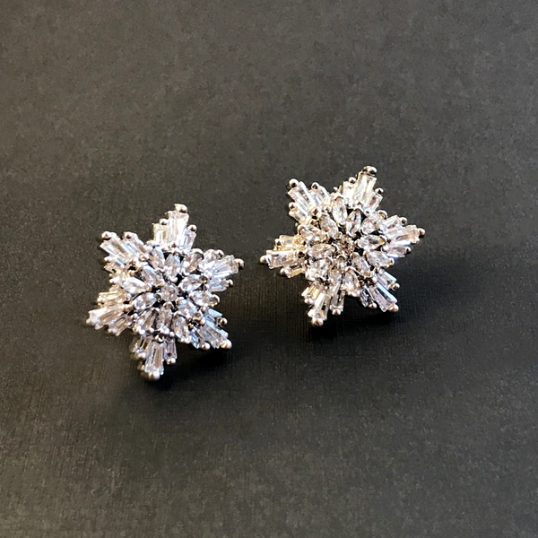 Flower shaped swarovski crystal marquee cut stud earrings on a black background