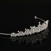 Bridal silver tiara with peaks of sparkling gemstones in a flowing floral pattern